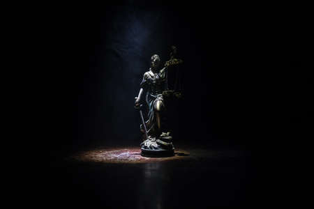 Law concept. Miniature colorful artwork decoration with fog and backlight. The Statue of Justice -...
