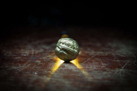 Still life with Walnut kernels and whole walnuts on rustic old wooden table. Creative table decoration. Closeup. Selective focusの写真素材