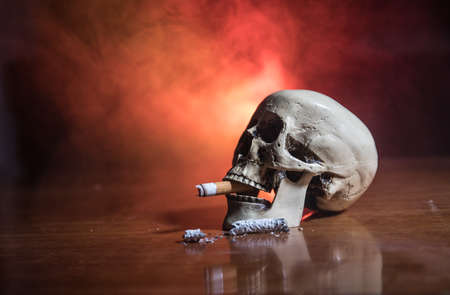 No smoking concept. Creative artwork table decoration with cigarettes. Cigarettes cause cancer and...