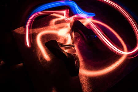 Artwork decoration. Silhouette of a high heel women shoes at dark. Women power or women domination...