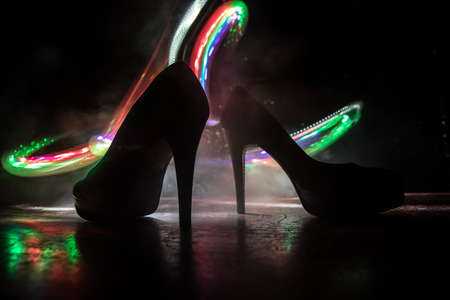 Artwork decoration. Silhouette of a high heel women shoes at dark. Women power or women domination concept. Selective focusの写真素材