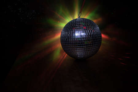 Colorful disco mirror ball lights night club background. Party lights disco ball. Selective focus