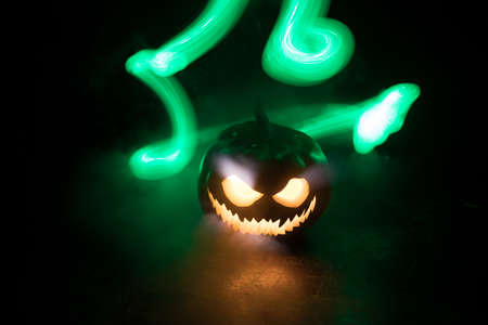 Halloween pumpkin smile and scary eyes for party night. Close up view of scary Halloween pumpkin...