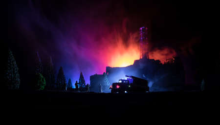 Creative artwork decoration. Chernobyl nuclear power plant at night. Layout of Chernobyl station during nuclear reactor explosion. Fire fighters at work. Selective focusの写真素材