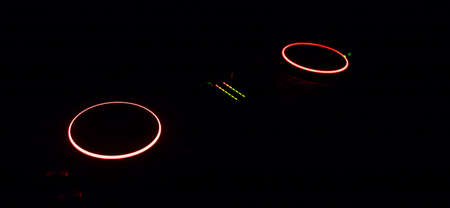 Club music concept. DJ console deejay-mixing desk in dark with colorful light. Mixer equipment...