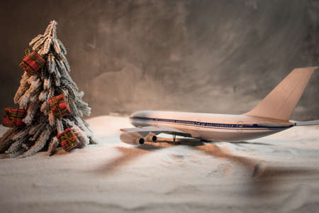 Merry Christmas and Happy new years travel concept background for winter trip. Christmas background with airplane. Creative artwork decoration on snow. Selective focus.の写真素材