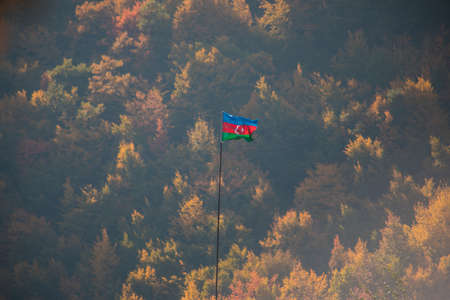 Azerbaijan flag, Waving flag on the mountain. National flag of Azerbaijan on strong wind in the sunny day. Outdoor nature shotの写真素材