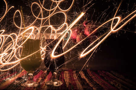 New Year and Christmas party concept. Different tasty cocktails with creative New Year holiday artwork decoration on background. Colorful cocktail in glass. Party club entertainment. Copy space.の写真素材