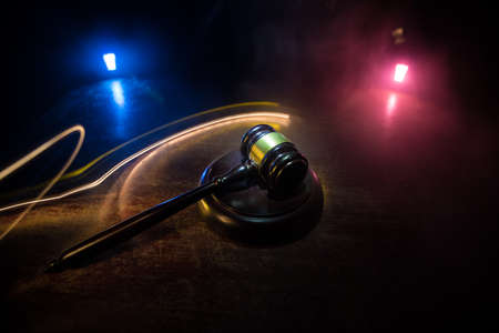 Law, justice concept. Creative artwork table decoration with mallet of the judge on dark foggy...