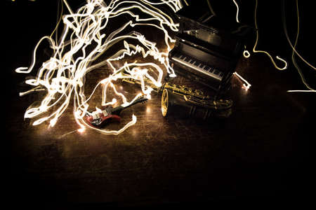 Music concept. Saxophone jazz instrument. Alto gold sax miniature with colorful toned light on foggy background. Musical instruments in lowlight. Selective focusの写真素材