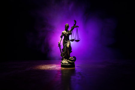 Law concept. Miniature colorful artwork decoration with fog and backlight. The Statue of Justice - lady justice or Iustitia / Justitia the Roman goddess of Justice. Selective focusの写真素材