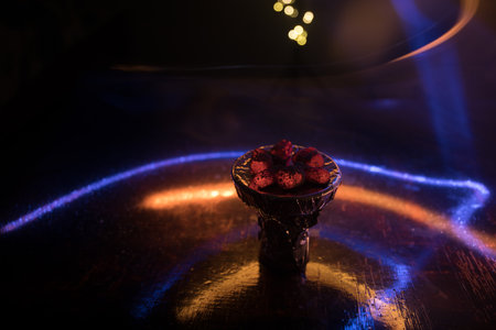 Close-up of burning charcoal cubes. Action. Cubes of embers burning in bowl for smoking hookah. Creative artwork decoration on dark background. Empty space. Selective focusの写真素材