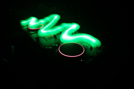 Club music concept. DJ console deejay-mixing desk in dark with colorful light. Mixer equipment entertainment DJ station. Selective focusの写真素材