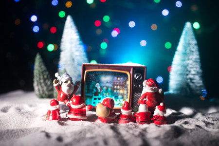 Creative Christmas concept. Vintage television set on snow with Santa Claus. Artwork decoration.の写真素材