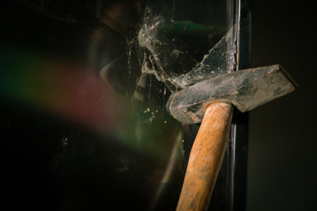 Broken led screen hit by a hammer. The concept of hatred of television, modern technology and talk shows and news. Destroyed television in living room.の写真素材