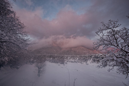 Majestic sunset in the winter mountains landscape. Dramatic sky. Azerbaijan nature. Shaki