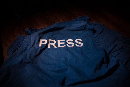 Media Journalism Global Daily News Content Concept. Blue journalist (press) vest in dark with...