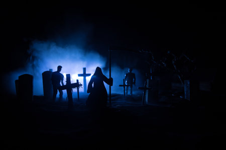 Scary view of grim reaper at cemetery with spooky cloudy sky and fog, Horror Halloween concept. Selective focusの写真素材
