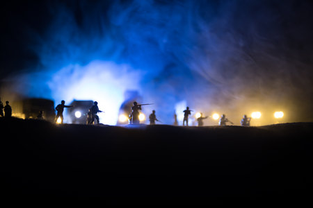 War Concept. Military silhouettes fighting scene on war fog sky background, World War Soldiers Silhouette Below Cloudy Skyline At night. Selective focusの写真素材
