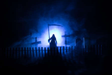 Scary view of zombies at cemetery dead tree, moon, church and spooky cloudy sky with fog, Horror...