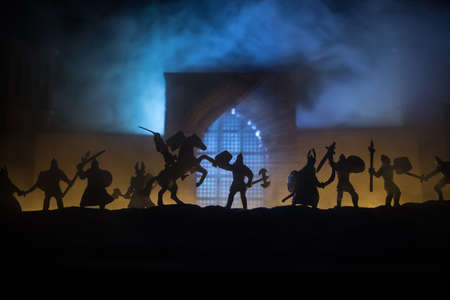 Medieval battle scene. Silhouettes of figures as separate objects, fight between warriors at night....