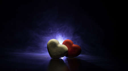 Valentines background. Valentine's Day heart on a dark wooden table. Dark toned foggy background....