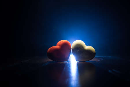 Valentines background. Valentine's Day heart on a dark wooden table. Dark toned foggy background. Selective focusの写真素材