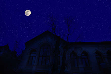Old city streets at night. Full moon over the city at night, Baku Azerbaijan. Big full moon shining bright over buildingsの写真素材
