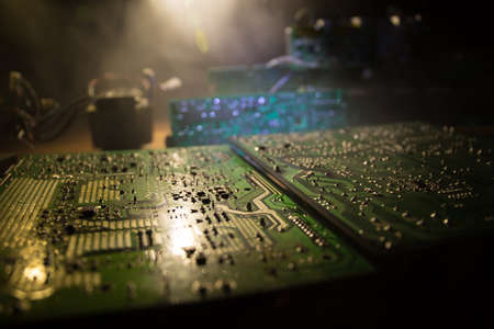 Creative concept of modern technology, inside an electronic device. Electronic circuit board close up in low key. Selective focusの写真素材