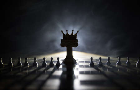 Beautiful crown miniature on chessboard. chess board game concept of business ideas and competition...