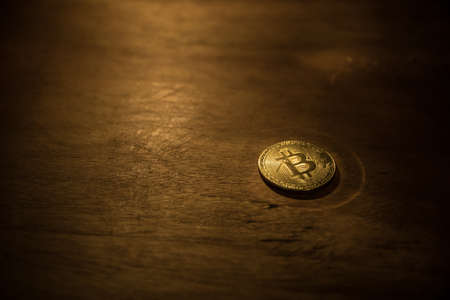 Golden Bitcoin on dark backround. New virtual money. Crypto currency. Creative artwork decoration. Selective focusの写真素材
