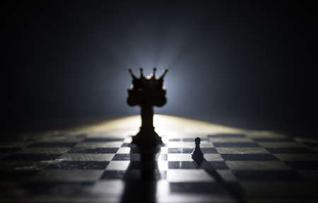 Beautiful crown miniature on chessboard. chess board game concept of business ideas and competition...