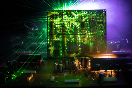 Creative concept of modern technology, inside an electronic device. Electronic circuit board close up in low key. Selective focusの写真素材