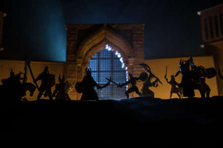 Medieval battle scene. Silhouettes of figures as separate objects, fight between warriors at night....