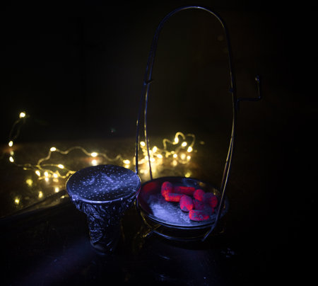 Close-up of burning charcoal cubes. Action. Cubes of embers burning in bowl for smoking hookah....