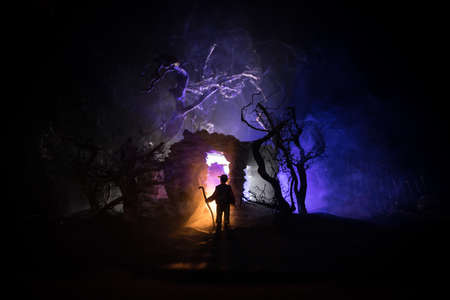 Old stone house burning uncontrollable in the night. A fire in a country house. Creative artwork decoration. Selective focusの写真素材