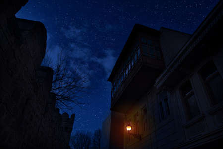 Old city streets at night. Full moon over the city at night, Baku Azerbaijan. Big full moon shining bright over buildingsの写真素材