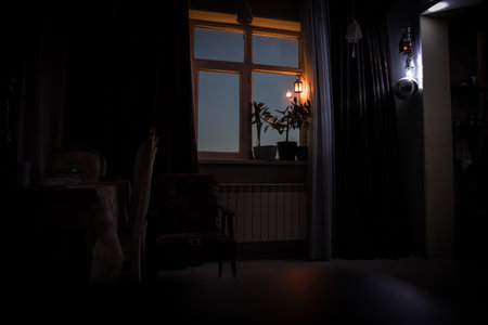Night scene of moon seen through the window from dark room. Moonlight inside dark roomの写真素材