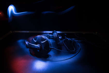 Dj music club concept. Close up headphones on dark background with colorful light. Selective focusの写真素材