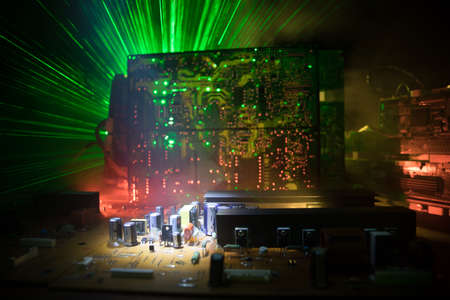 Creative concept of modern technology, inside an electronic device. Electronic circuit board close up in low key. Selective focusの写真素材