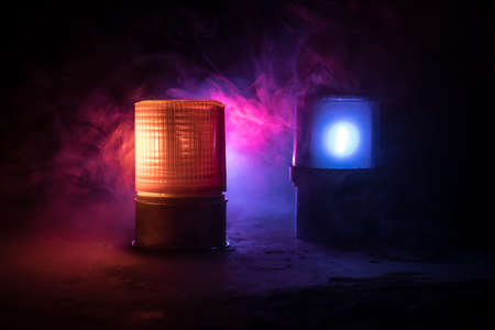 Police car blue and red round vintage siren in dark. Rotating retro style police siren. Selective focusの写真素材