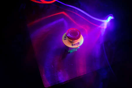 Emergency stop button, Disaster protection. Industrial concept. Red button on table in dark low key background. Selective focusの写真素材