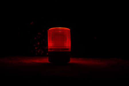 Police car red round vintage siren in dark. Rotating retro style police siren. Selective focusの写真素材
