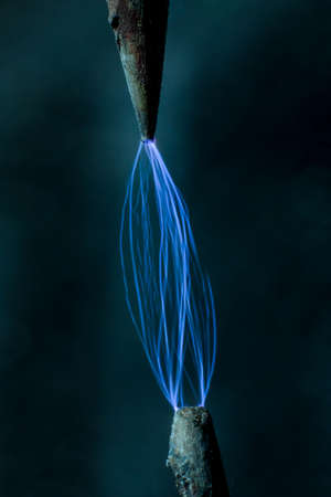 Realistic glowing electricity lightning between two electrodes. Industrial electricity concept....