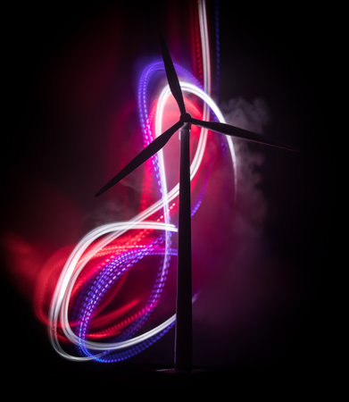 Electricity power in nature or clean energy concept. Wind Turbine producing alternative energy on hill at night. Creative decoration with small miniature. Selective focusの写真素材