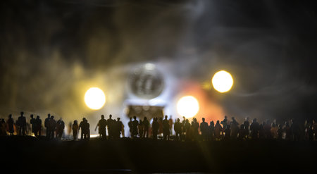 Golden Bitcoin on dark backround. New virtual money. Crypto currency. Crowd miniature looking on...