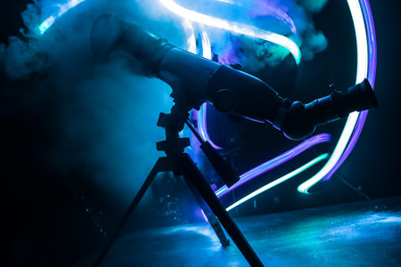 Silhouette of a astronomy telescope on dark foggy backlight. Selective focusの写真素材