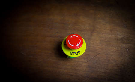 Emergency stop button, Disaster protection. Industrial concept. Red button on table in dark low key background. Selective focusの写真素材