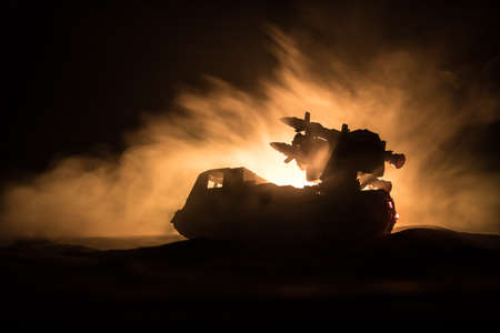 War concept. Battle scene with rocket launcher aimed at gloomy sky at night. Rocket vehicle ready to...