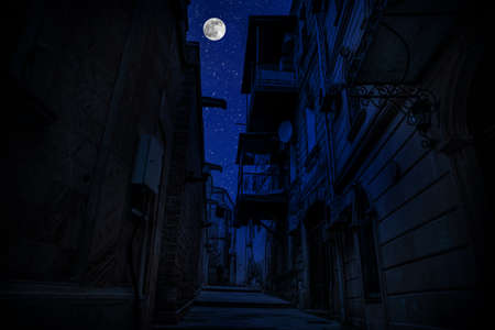 Old city streets at night. Full moon over the city at night, Baku Azerbaijan. Big full moon shining...